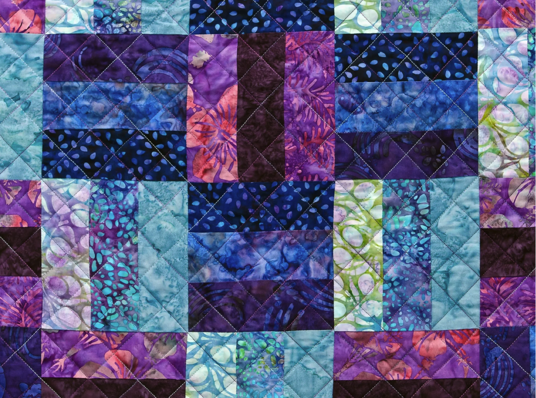 QuiltLab patchwork quilt with blue, turquoise, and purple batik fabrics